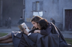 a female student hugs another student while read a book 