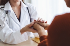 Patient holding hands with doctor
