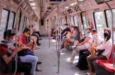 people wear masks on a train in singapore