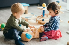 Toddlers playing with toys indoors