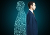 a man in a suit stands beside digital circuitry in human shape