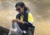 Tashya Miranda at work taking water samples