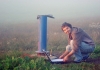 Dr Gabriel Rau downloads groundwater data from a bore