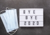 A lightbox with message 'bye bye 2020' alongside two surgical masks