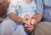 ageing couple holding hands