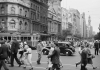 commuters walk past cars and trams in the melbourne CBD in the 1950s