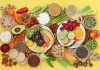 Fruits, vegetables, nuts and whole grains sit on a yellow background