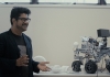 Dr Eduardo Benitez Sandoval beside a four-wheeled robot used in the Creative Robotics Lab