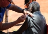 A senior Aboriginal man receiving a COVID-19 vaccine