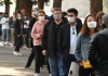 People waiting in line with masks on