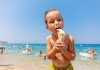 child eating ice cream at the beach