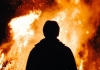 Man stands in front of fire