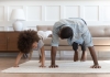 father and daughter doing exercise in living room