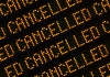 A Close Up Of The Word Cancelled Repeated Multiple Times On A Sign At A Station Or Airport