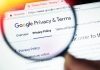 Magnifying glass being held up to Google's Privacy & Terms page