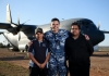 Tjapukai Shaw, RAAF Indigenous liaison officer, with two young Indigenous men in front of a large aircraft