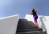 A woman runs up an outdoor staircase
