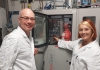 Professor Richard Tilley and Dr Lucy Gloag in front of a hydrogen filling station