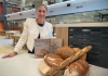 Associate Professor Sara Grafenauer posing with bread and cookbooks