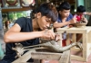 junior craftsmen making copper handicraft products in traditional method