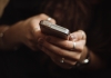 A woman's hand holding a mobile phone