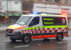 NSW Ambulance driving through a shopping centre