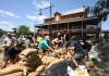 people sandbagging a shop in a regional town in australia