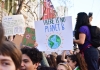 protesters hold a sign up saying there is no planet b