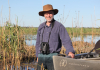richard kingsford stands in a wetland