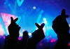 K-Pop music live concert background with silhouette hands of audience making mini heart shaped hand gestures