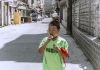 Boy eating an ice cream on an abandoned street in China 