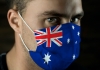 A man's face with an Australian flag mask