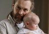 Close-up portrait of a man holding a baby