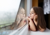 Young girl gazing out of a window