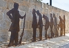 silhouettes of colonial convicts and an armed guard