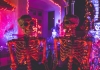 Two skeleton Halloween decorations in neon light