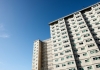 social housing apartment tower block against a blue sky