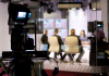 Media TV studio with focus on camera shooting a news production.