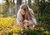 teenage girl holding magnifying glass explores nature and the environment