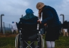 Woman talking to man in a wheelchair