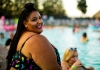Smiling plus sized woman beside pool