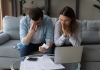 worried young couple deal with stress of housing costs