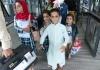 young afghan children leave an airport after leaving the country