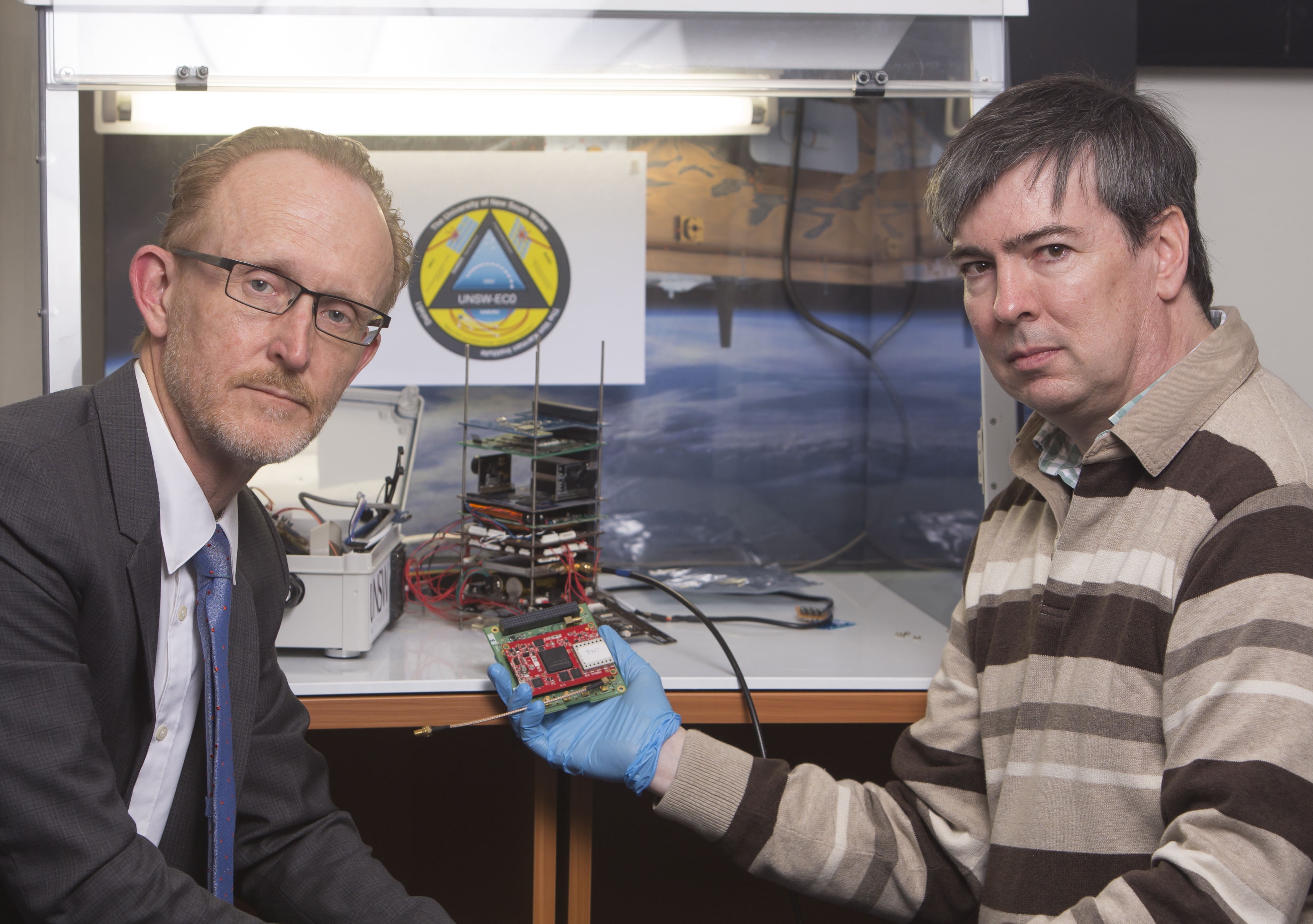 Professor Andrew Dempster (left) and Dr Eamonn Glennon of UNSW&#039;s Australian Centre for Space Engineering Research with an early version of their space-ready receiver. Photo: Quentin Jones