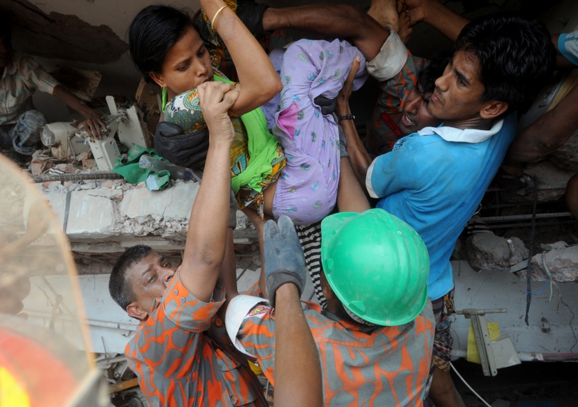 Rescuers help garment workers escape the collapsed section of the Rana Plaza building in Bangladesh in 2013. Photo: Shutterstock